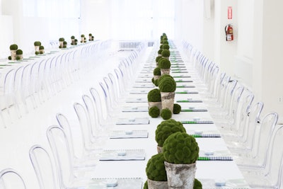 The Women's Wear Daily Beauty Summit in 2013 had a sleek, all-white design from Shiraz Events. Guests sat in clear Miro chairs at communal tables topped with white linens and simple birch vases holding cobble moss balls.
