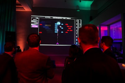 Guests could play the classic video game Space Invaders in a modern format: Quince Imaging projected onto the walls of the venue.