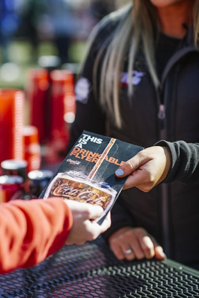 Coca-Cola distributed “drinkable flyers” that had a straw embedded in them and also included a coupon for a free Coke Zero from a concession stand inside Lucas Oil Stadium.