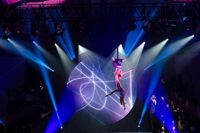 Throughout the show, dancers performed a tango in midair on a bungee rope, cirque performers contorted, stilt walkers paraded down the aisles, and aerialists dangled above the audience while musicians and vocalists performed musical mash-ups at each destination. The whole program benefited the Sunshine Kids Foundation.