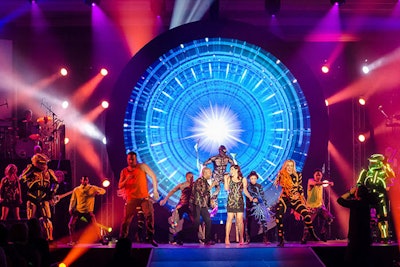 To underscore the message that the keys to success—a play on the home theme—had been turned over from Berkshire to the sales network, an enormous LED medallion emblazoned with the word “Revolution” was placed on center stage, with a keyhole that appeared to unlock all the event's content. A turntable on stage rotated the medallion, revealing each different aspect of the production, including a contemporary dance show and a singer performing a song composed specially for the event by Corporate Magic C.E.O. Jim Kirk. Beyond that, more than 1,500 agents were invited to the stage and recognized with their names, sales results, and rankings hovering on the screens above their heads.