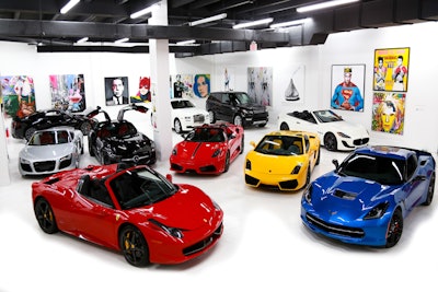 Showroom with cars and art.