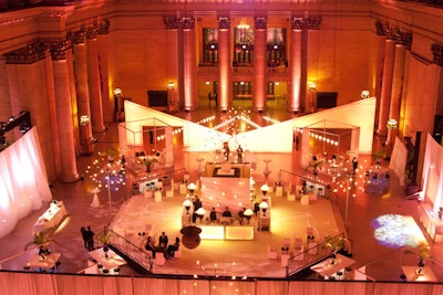 Custom illuminated walls and sputnik chandeliers light up a corporate event at Chicago's Union Station