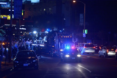 Runners and fans who joined the group followed behind a flatbed truck as Kendrick Lamar performed.