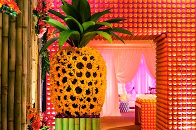 Custom floral work and backdrops cover the entrance of the Four Seasons for a tropical, fruit themed event.
