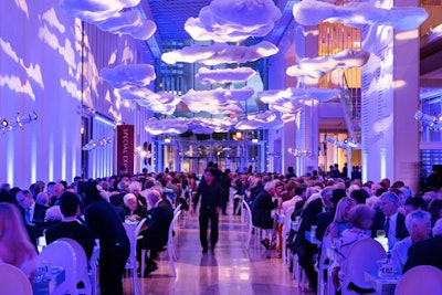 Custom cloud shaped props hang from the ceiling for the Magritte opening gala decor at the Art Institute Chicago