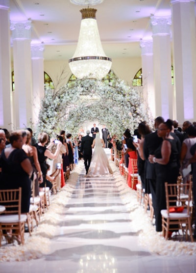 'A bride walked down the aisle past her 450 guests beneath arches of 6,000 cherry blossoms.'