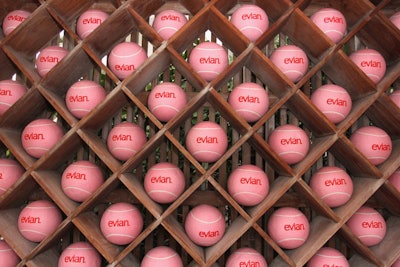 Decor at the event included a wall of oversize tennis balls with the Evian logo.