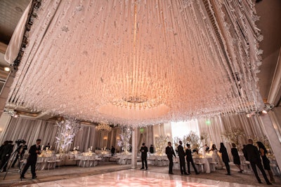 'Some 8,000 hand-tied crystals were suspended from the ceiling above the dance floor, bringing to life a groom's vision for a dramatic all-white wedding for 280 guests '