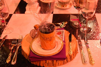 A checkerboard table covering and mismatched gold and silver cutlery added to the mad tea party theme at the gala. Guests received mugs and tea strainers as party favors from Canadian tea seller Teaopia, which is now owned by Atlanta-based retailer Teavana.