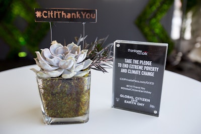 Copper and steel branded stakes with the #CitiThankYou hashtag accented tabletop succulents.