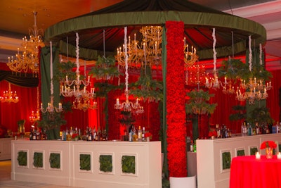 'A holiday party bar was fully transformed into a decadent winter wonderland with the use of 11,000 red roses, fresh seasonal greenery, crystal and ‘live’ chandeliers, and ‘living’ bar fronts.'