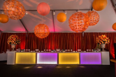 Design Foundry suspended different sizes and styles of orange lanterns from the ceiling of the reception tent.