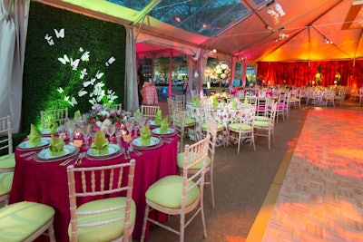 The design team chose a springtime color palette of pink, orange, green, yellow, and green for the linens, flowers, and lighting in the dinner tent.