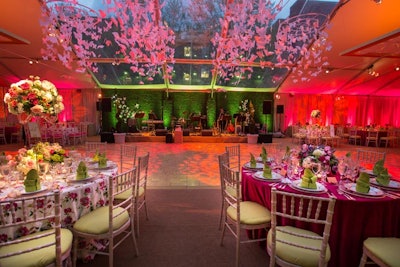Yours Truly Lighting used pink, green, and orange uplights to complement the decor inside the dinner tent.