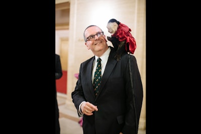 Sporting a festive red dress, 'Mindy the Monkey' interacted with guests including the opera's general director, Anthony Freud (pictured).