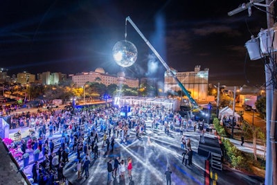 A disco ball measuring 20 feet in diameter presided over the launch event for the real estate development Paramount Miami Worldcenter.