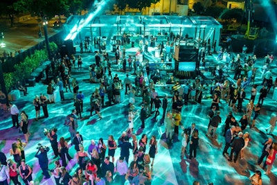 The outdoor event took place in the development's sales center parking lot with a clear tent in place in case of rain. Since it was a clear night, the tent served as a lounge.