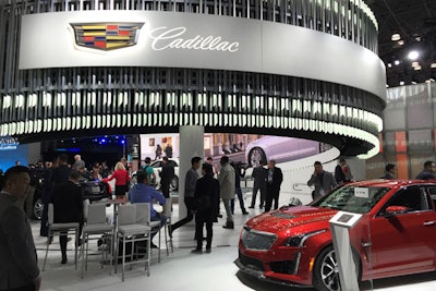 Cadillac's effort was perhaps the most visible—and brightest—of all the auto show sets at the Javits Center, with hundreds of metal vertical slats forming the outer layer of the main stage iris. Directly adjacent to the glass-topped stage and bar-cum-lounge area was a massive wall featuring the Piet Mondrian-esque patterned Cadillac crest, the electrochromic glass composition of which changed its opacity throughout the day to pre-set choreography.