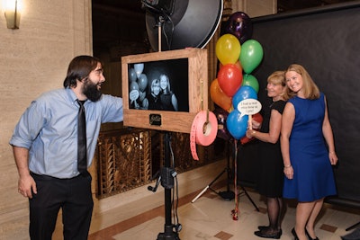 Fotio brought in a vintage-style camera decked with a roll of carnival tickets. Guests posed with colorful balloons and signs that referenced songs from Carousel.