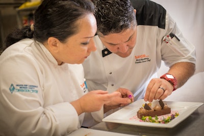 Executive Chef Chef Marcel Martinez and his assistant put the finishing touches on a delectable dessert dish