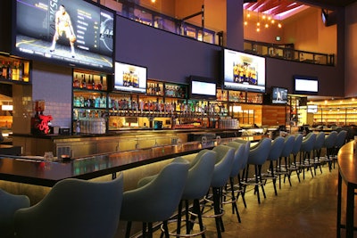 The Tom's Urban sports deck features high tops, a bar, and booth seating.