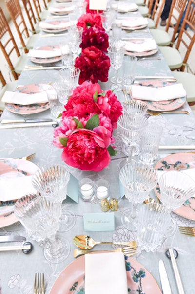 Also from de Gournay were the custom-printed tablecloths that adorned each of the 64 dinner tables. Peonies in shades of red and hot pink were exclusively used as the table centerpieces, while seat cards were fashioned in a pastel blue. The wood-backed seats, dressed up and covered in year's past, were purposefully left untouched.