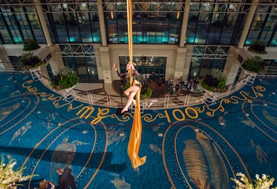 An aerial acrobat performs for guests of the Mayor's Gala in the expansive atrium of the Broward County Convention Center