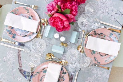 Dinner tables covered with de Gournay tablecloths featured centerpieces of red peonies in blue and white porcelain vases and chargers holding gold-rimmed plates. Gold was used sparingly as to avoid being cliché.