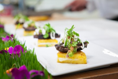 Sofrito Marinated Churrasco With Spiced Sour Cream And Avocado Atop Arepas Garnished With Cilantro