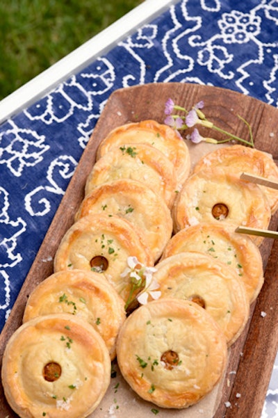 Guests snacked on mini brunch-theme bites, including breakfast hand pies, chicken and waffles, blintzes, and fruit parfaits.