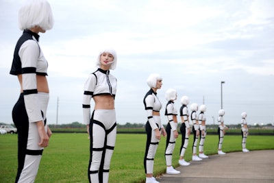A phalanx of female model staffers dressed in out-of-this-world space-age uniforms greeted guests as they arrived at the suburban Houston venue in Sugar Land.