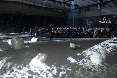 Five truckloads' worth of gravel combined with large rocks comprised the setting in which some 300 invited guests dined. More than 150 workers were enlisted to create the set, which was designed to transport guests to dinner on the surface of the moon.