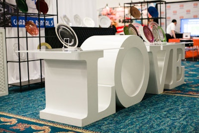 On the trade show floor, oversize letters served as a platform to display beautiful plates.