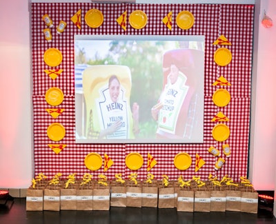 A summer picnic-like vignette surrounded a screen that showed Heinz's new commercials for its yellow mustard. Gift bags with a bottle of Heinz ketchup and two bottles of mustard—one to keep and one to share—stood underneath.