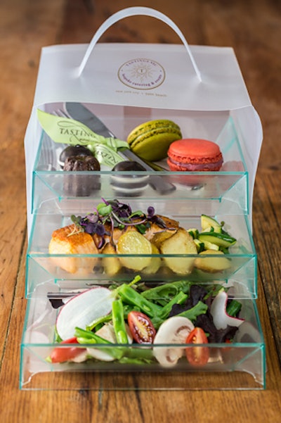 For an outdoor party, the team at Tastings, a catering company that serves New York, Miami, and Los Angeles, recommends offering lunch in elegant to-go bento boxes. At an event at the Glasshouses in New York in February, guests dined on a classic mesclun salad with button mushrooms, cherry tomatoes, and herb vinaigrette; seared arctic char with baby potatoes; and assorted macarons and canele for dessert, all presented in a three-tier translucent container.