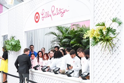 The register banks were gracefully concealed behind a branded trellis wall. Guests received pink-and-white Lilly Pulitzer for Target shopping bags when purchasing items.