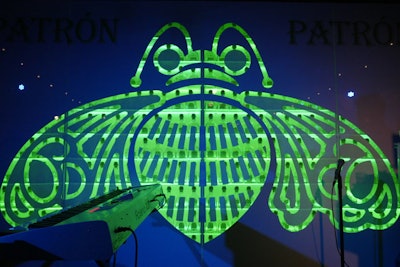 Behind the stage, illuminated Patrón bottles shined through a cutout of a bee, the brand’s logo.