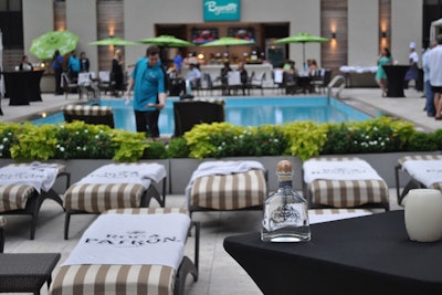 For a Patrón industry party at the Hyatt Regency New Orleans, branded towels were laid out on lounge chairs and the pool umbrellas were changed out to match the Patrón theme. Guests snacked on a create-your-own-nacho bar and Café Patrón mini cupcakes and traditional churros for dessert.