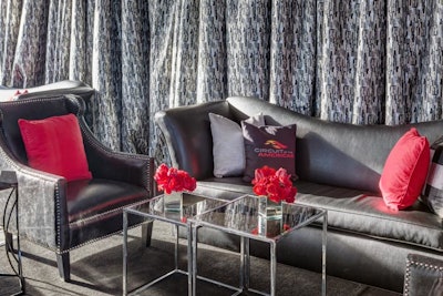 Caplan Miller Events worked with Cedar Park, Texas-based Townsley Designs to create a lounge area that included customized pillows and sleek, masculine furniture.