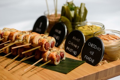 Blanketed mini franks with cheddar ale and sauerkraut mustard sauces, by Abigail Kirsch Catering in New York