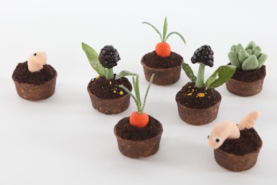 Salted dark chocolate pudding and cookie “dirt,” served with edible worms, carrots with fern leaf lavender, and blackberry “hyacinths” with candied tarragon and fennel pollen, by Relevant Events in Brooklyn, New York