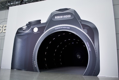 Guests entered the event through a giant camera lens, alluding to the portraits used throughout the decor and program.