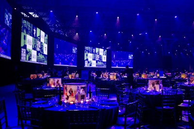 The dining room seated 4,000 guests. Sixteen screens lining the perimeter of the room gave all guests a close-up view of the stage, videos, and other elements of the program.