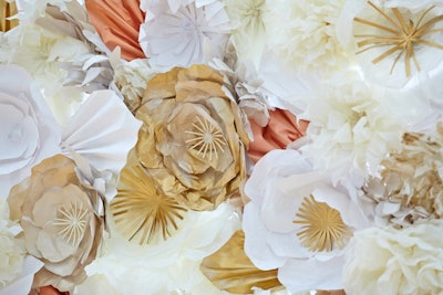 Instead of, or in addition to, traditional flowers, some couples are incorporating paper floral backdrops into their wedding decor. Lil Epic Event Design in Chicago provides such structures.