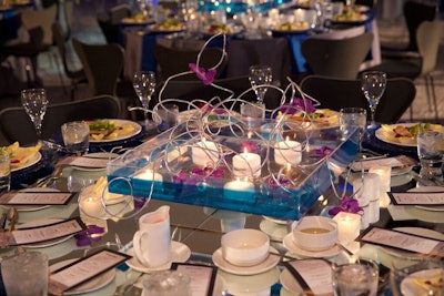 Some centerpieces held floating candles, orchids, and artfully twisted wires.
