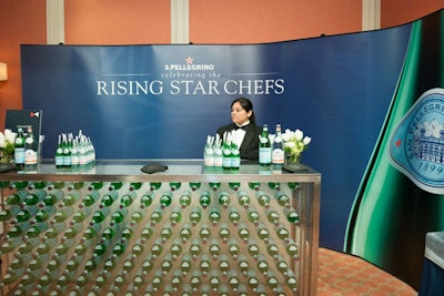 Accented with white flowers, Pellegrino's bar featured a clear base filled with artfully arranged bottles of the sparkling water.