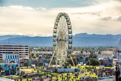 A Ferris wheel towers over the grounds, where nearly 50,000 square yards of synthetic turf covers the urban venue.