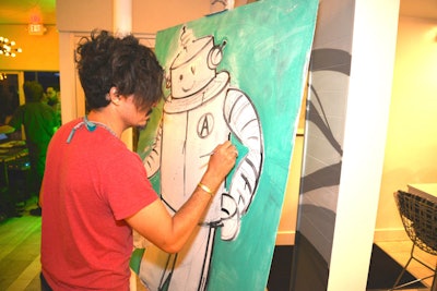 Local artist Juan Rozas entertained guests by painting “Ardie the Robot,” a character he created for the event.