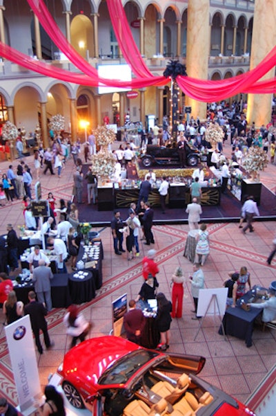 A vintage car and models dressed as flappers sat above the center of the main bar. Red drape from the second floor drew attention to the installation.